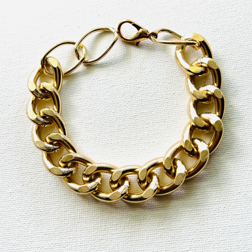 Chunky gold bracelet width 1.5 cm.